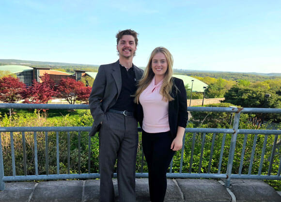 Jack Ashcom and Keira Hines smiling at Rocky Top Student Center with a beautiful view