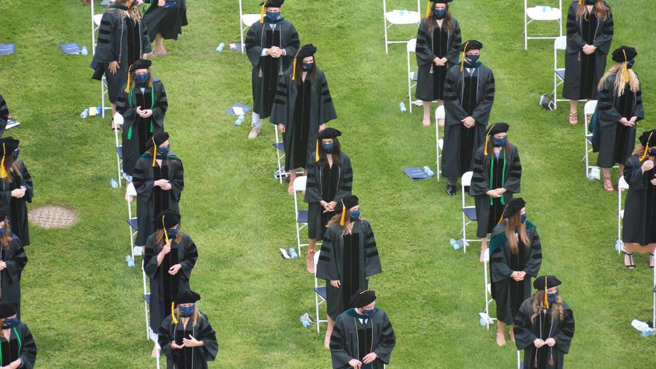 Several graduates participate in a Commencement ceremony