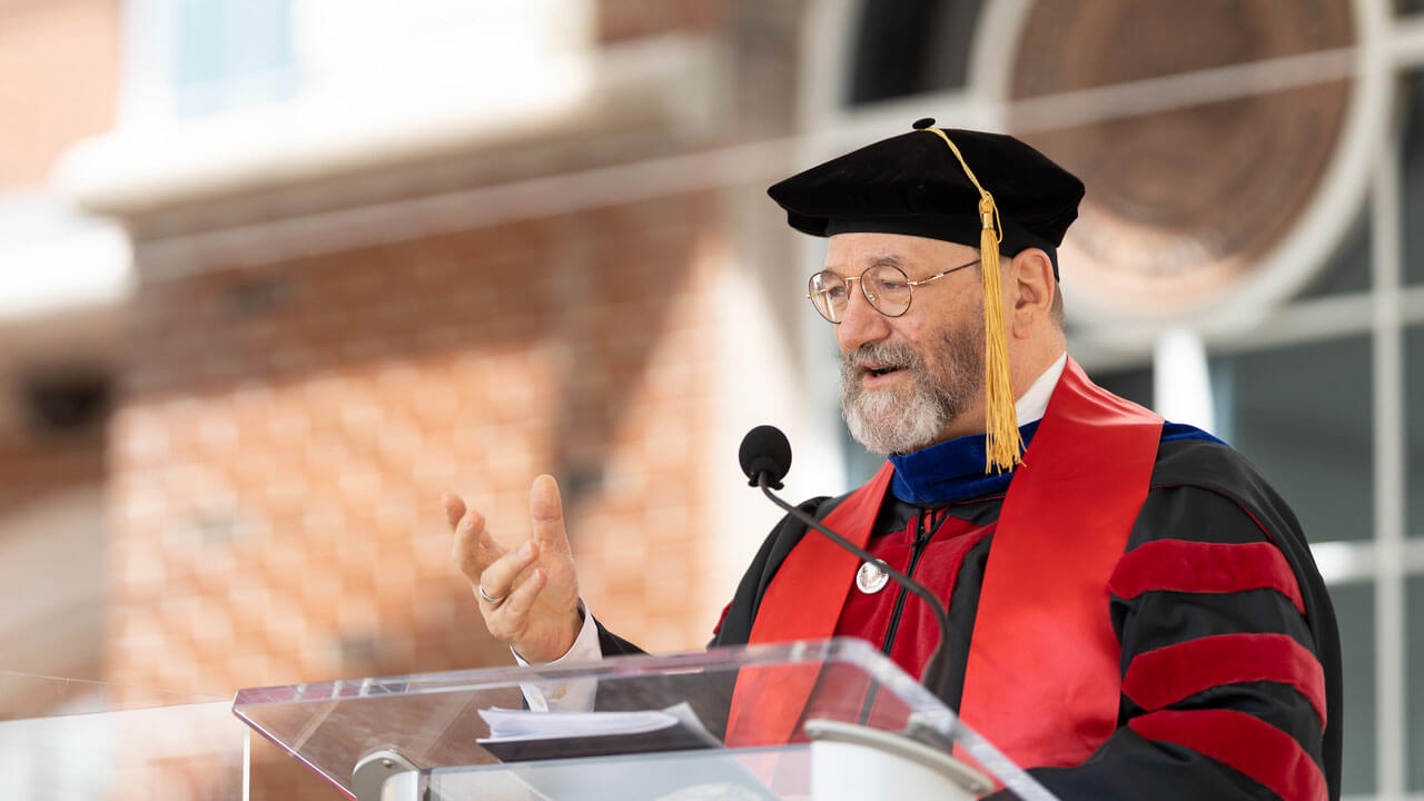 Dean Smart delivers his speech from the podium