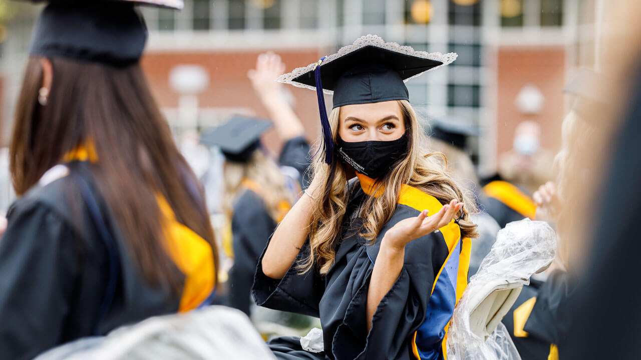 Student looking over her shoulder at ceremony