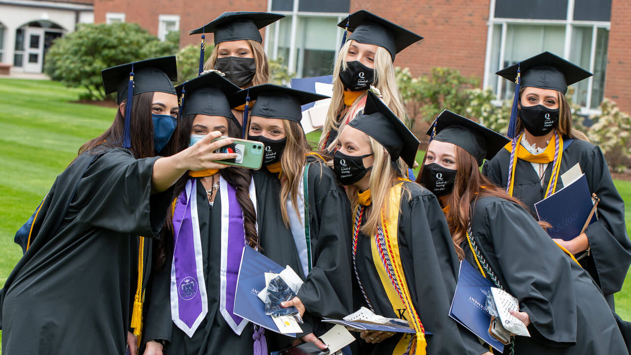 Several graduates pose for a group photo