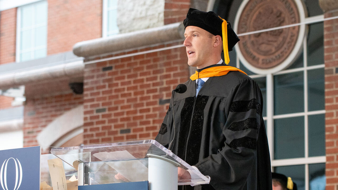 Gregory Foster delivers his remarks at the podium