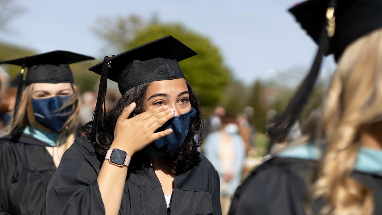 Girl wipes her tears away while standing in line