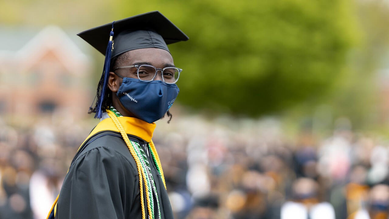 A graduate celebrates during Commencement