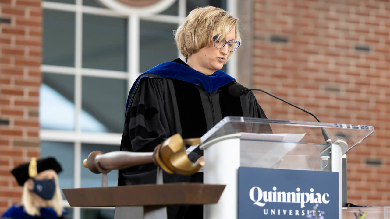 Sonja LaBarbera speaks to graduate students on podium