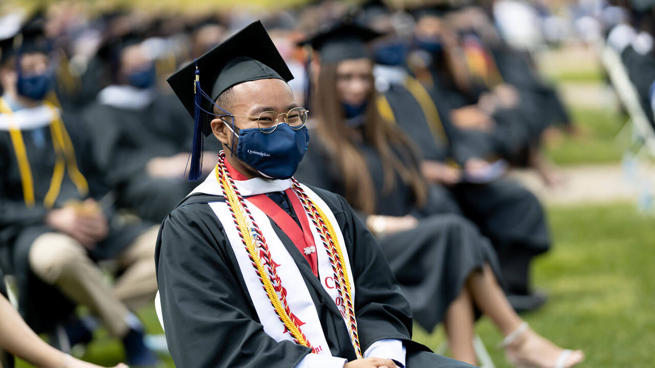 Students watching commencement speakers