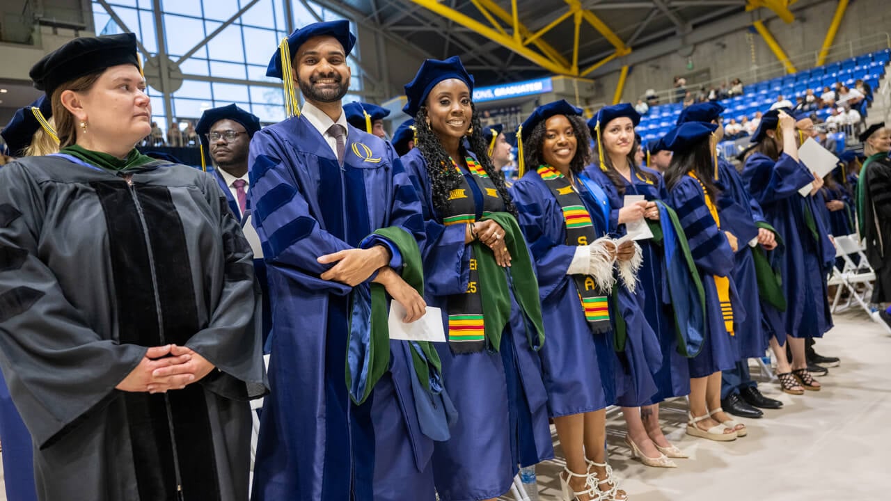 Students standing and smiling