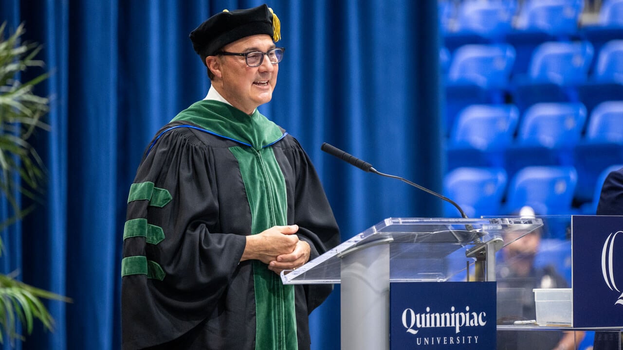 Frank H. Netter MD School of Medicine Dean speaks to the crowd at a podium.