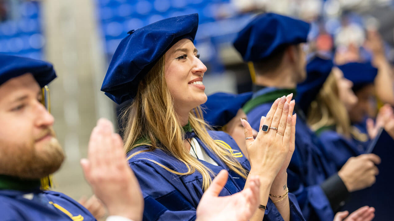 Graduate claps during ceremony