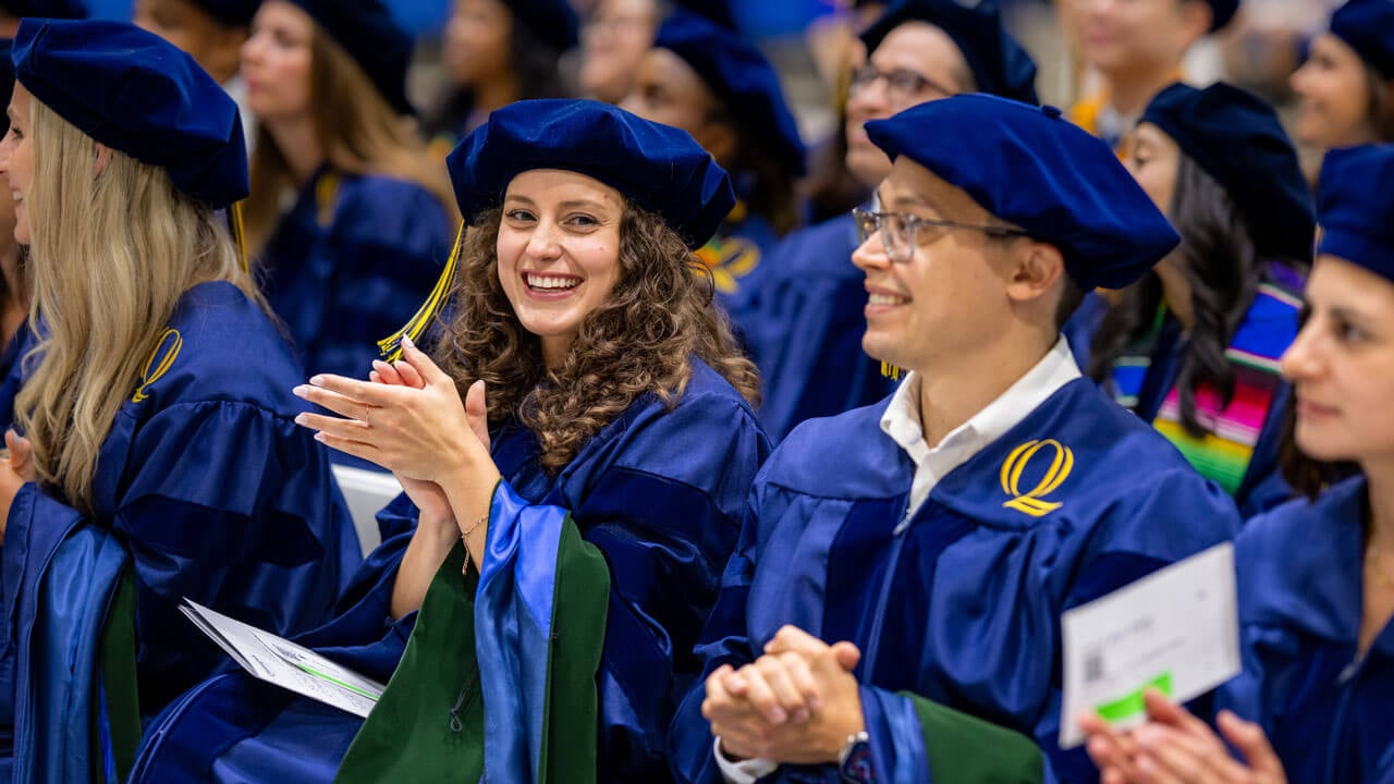 Graduates clap during ceremony