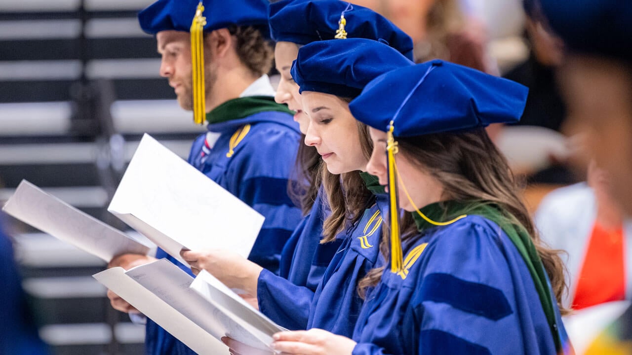 Graduate read oath during commencement ceremony.