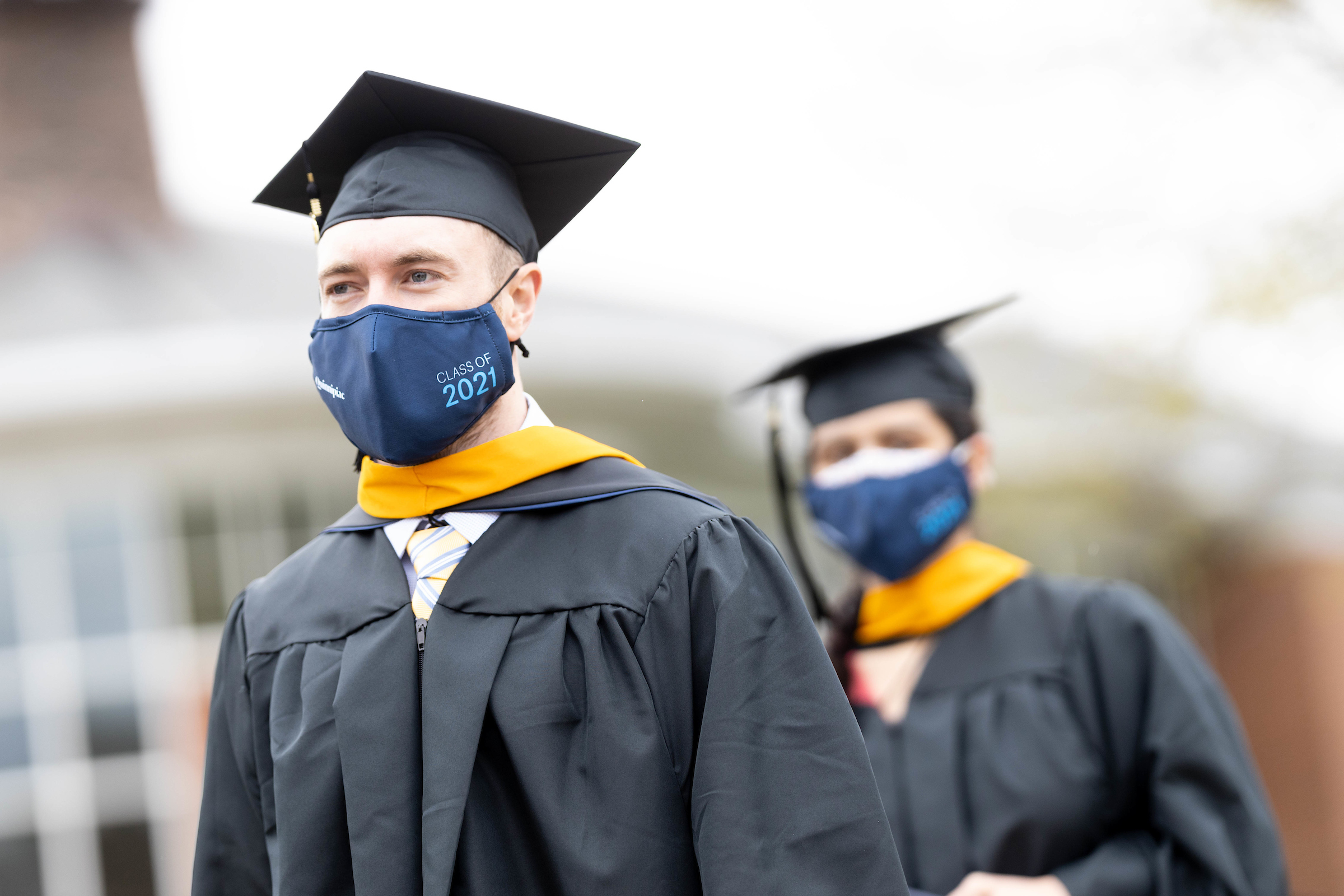Two students walking down aisle