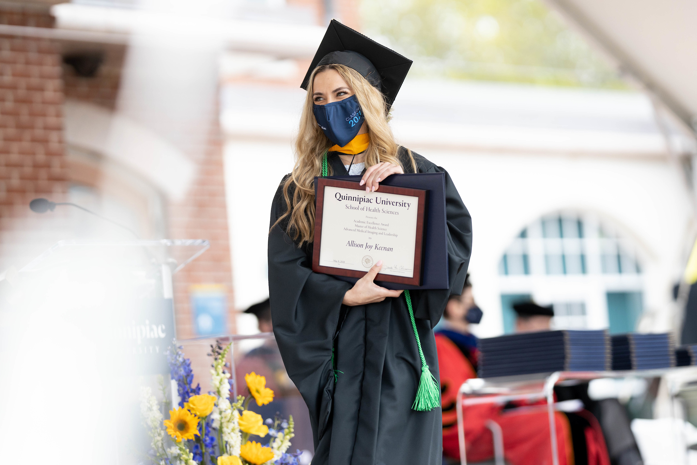 Allison Keenan holding her academic excellence award
