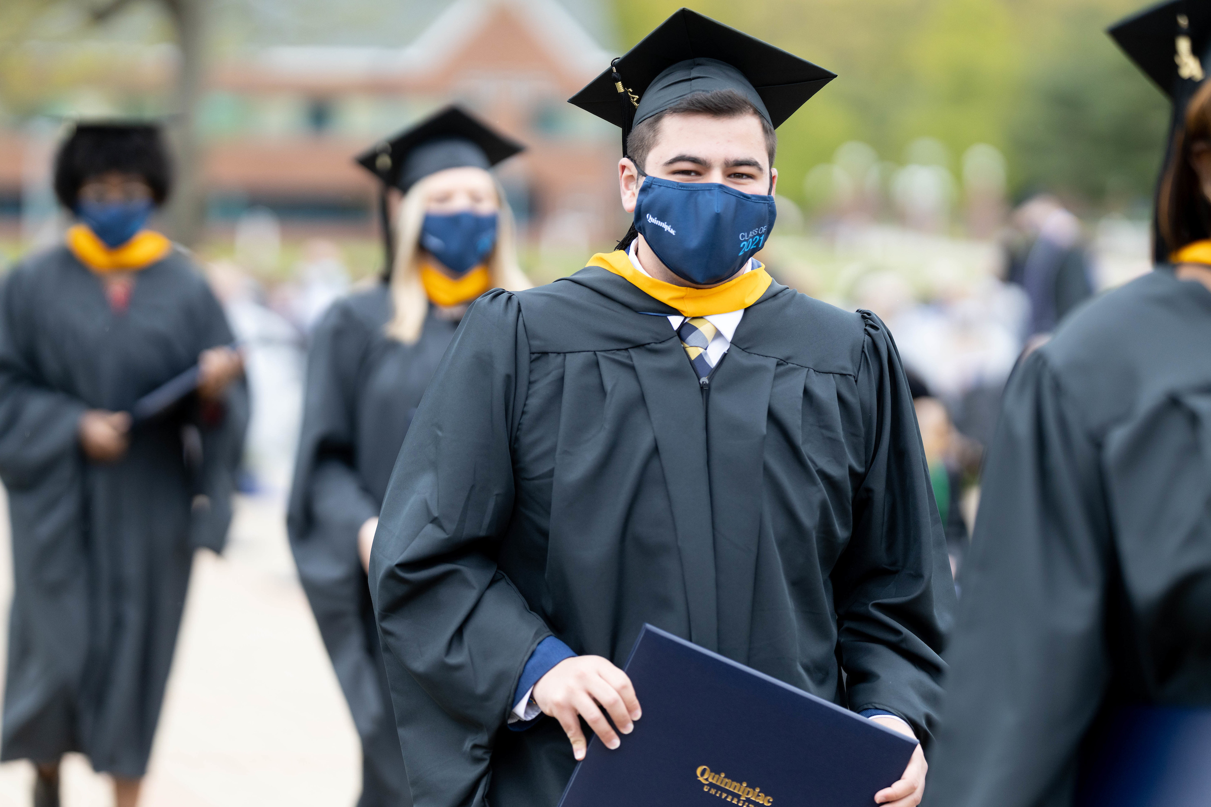 Students walking down aisle after receiving diplomas