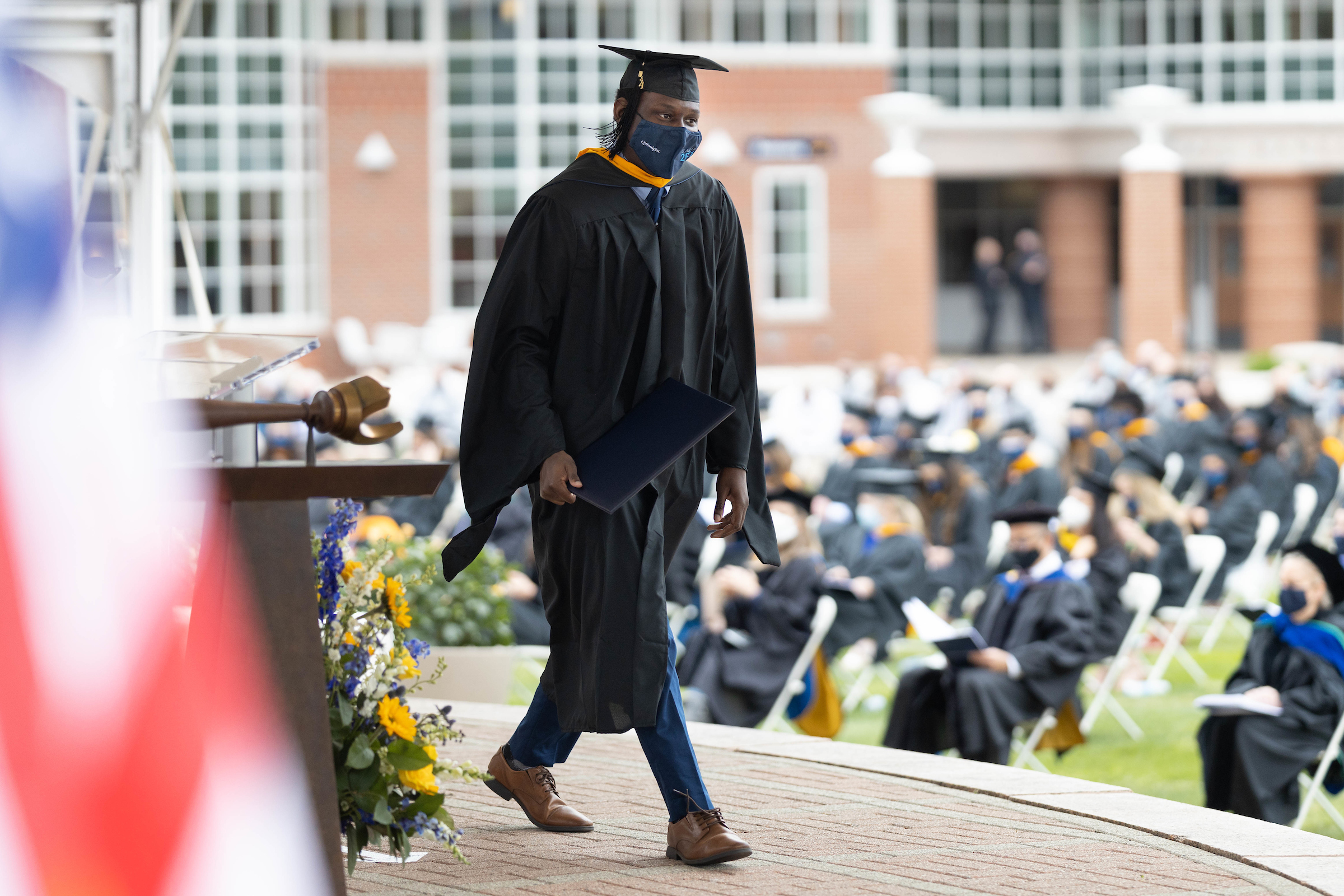 Student walking onto stage to receive diploma