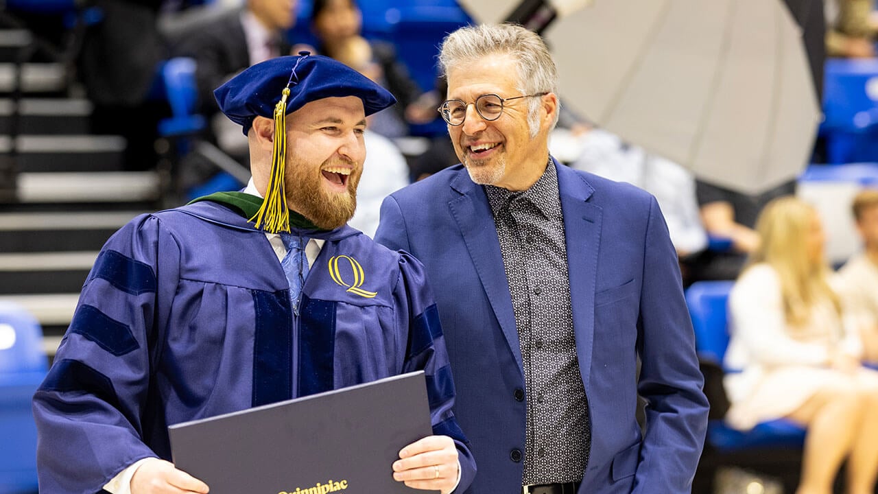 graduate poses with a loved one