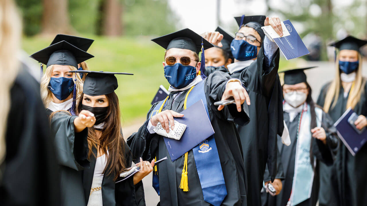 Students pointing at camera