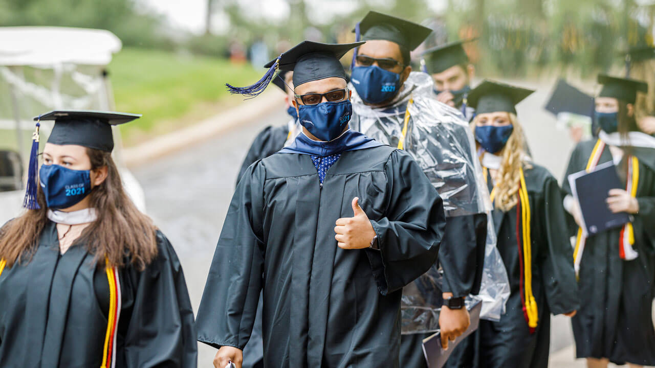Students wearing sunglasses and giving thumbs up