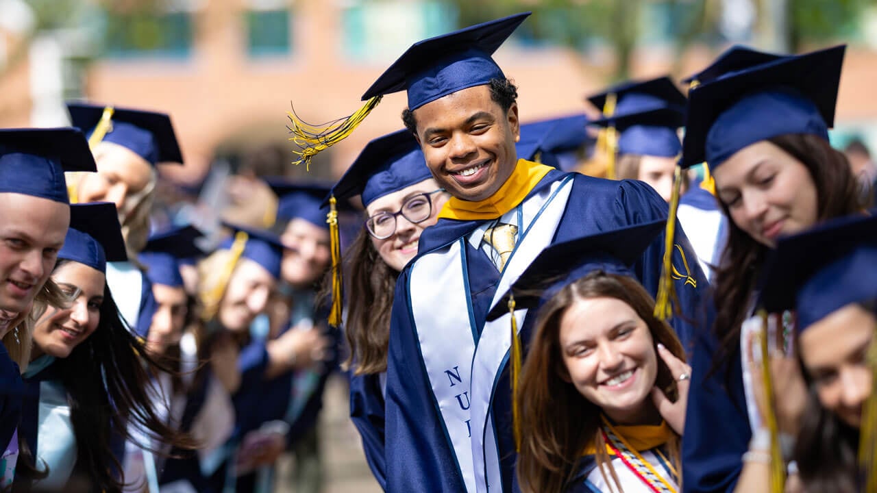 Graduate smiles in procession