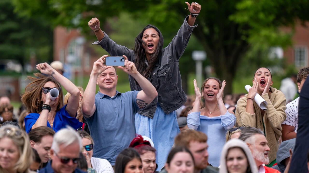 Family cheers in crowd.