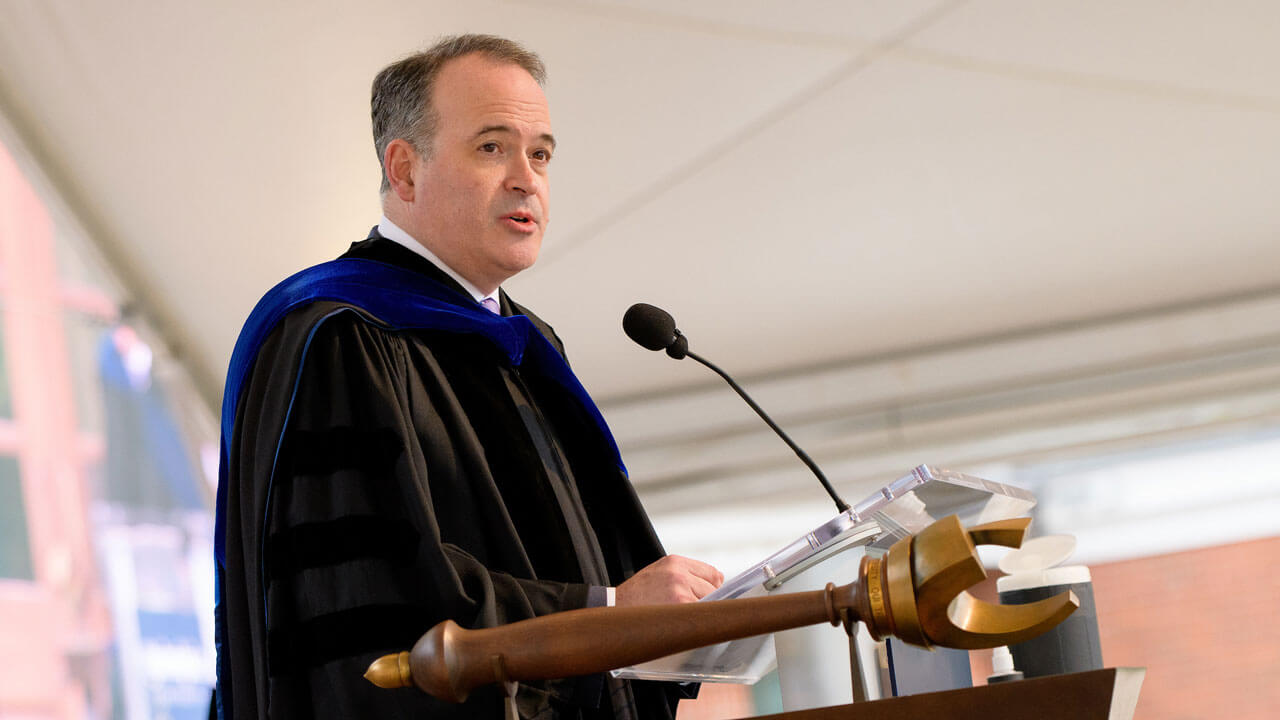 Matt Murray speaks at the podium on the library steps