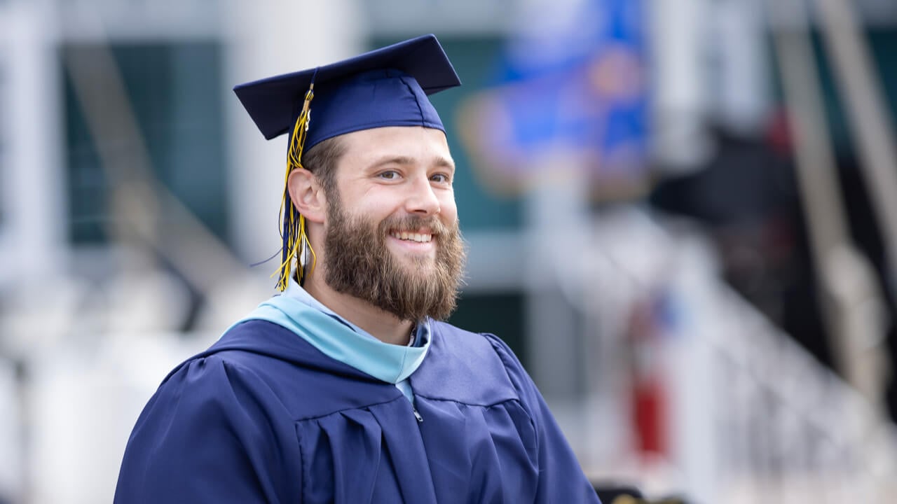 Male graduate smiling