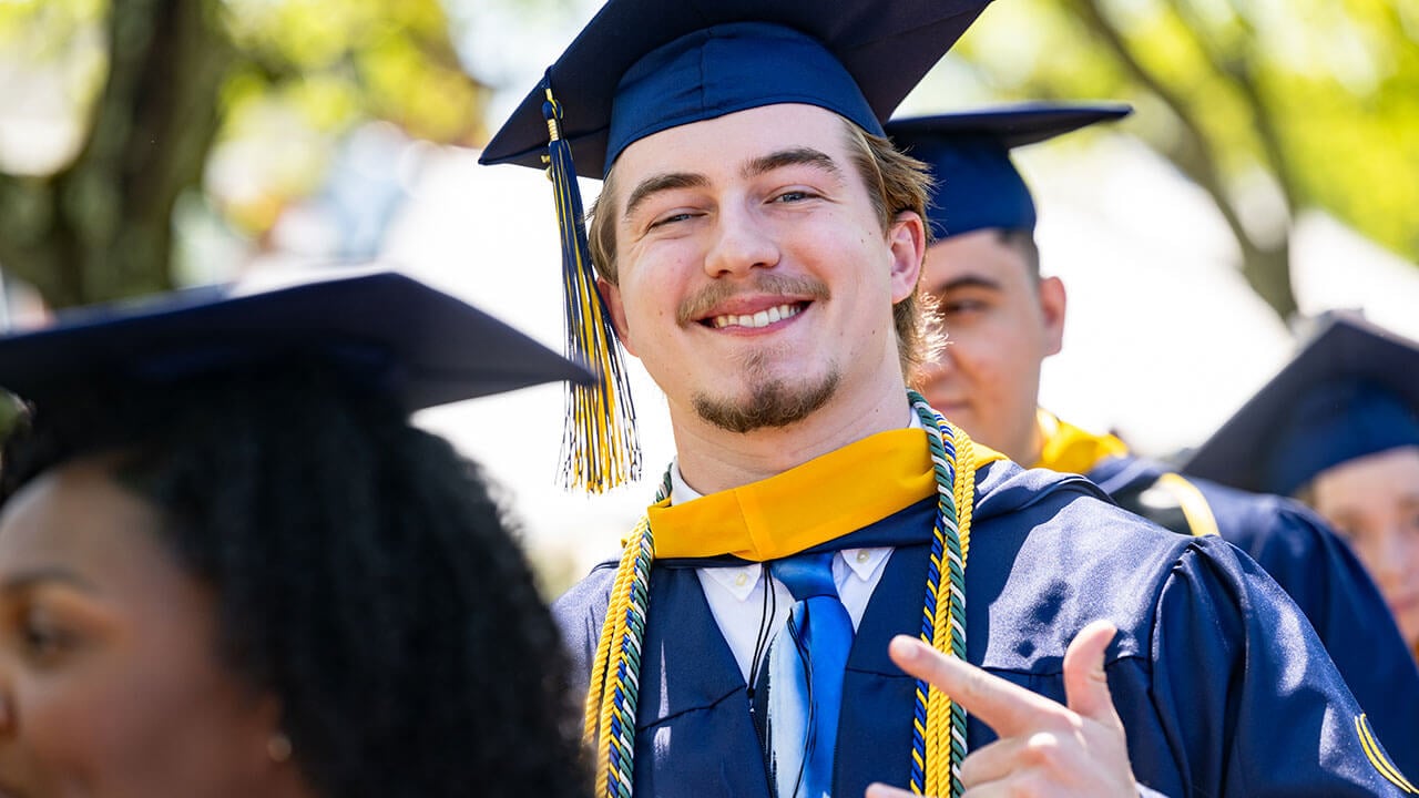 A graduate smiling