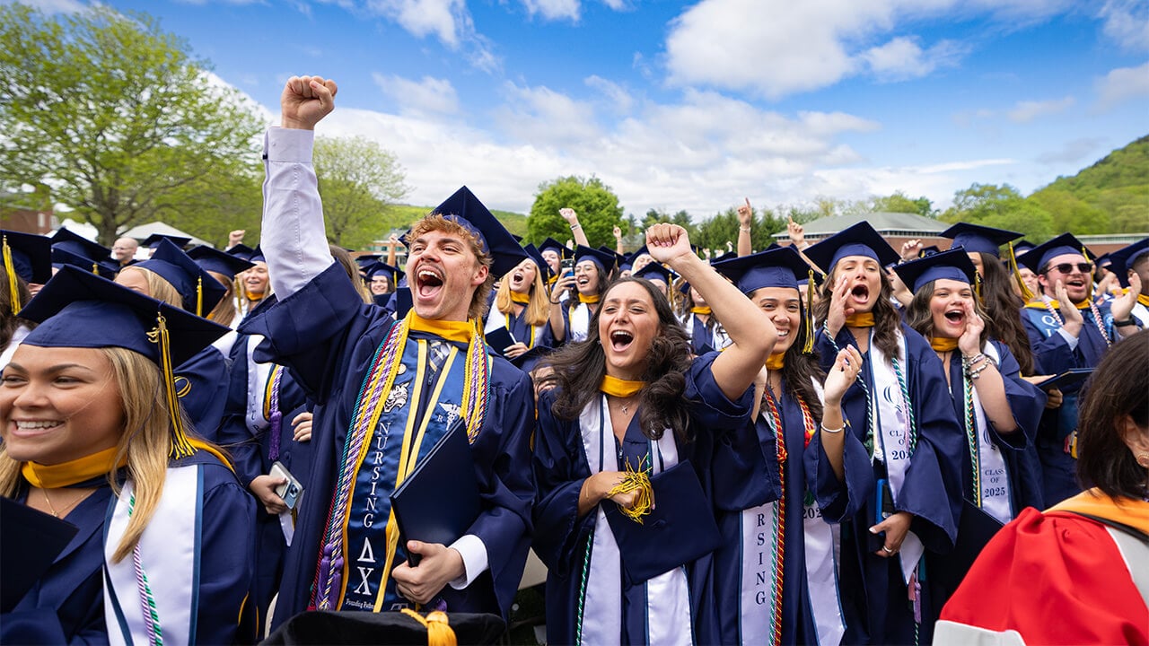 Graduating students cheer at commencement.