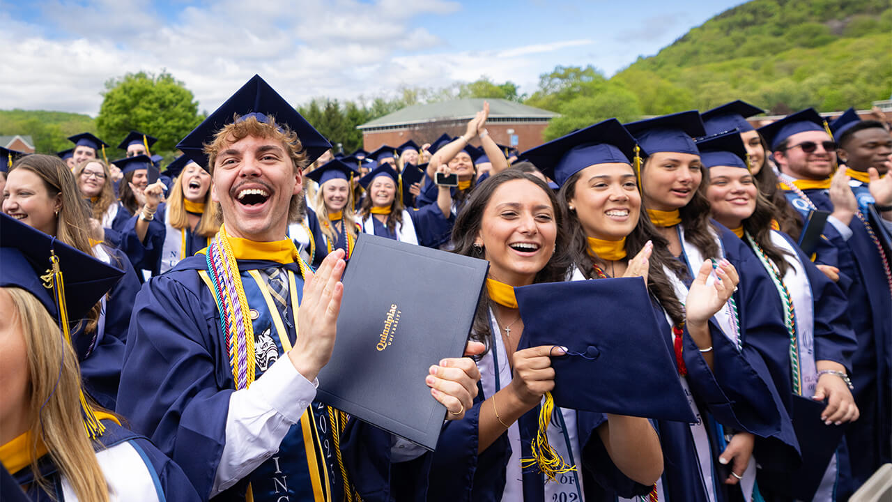 Graduating students cheer at commencement.
