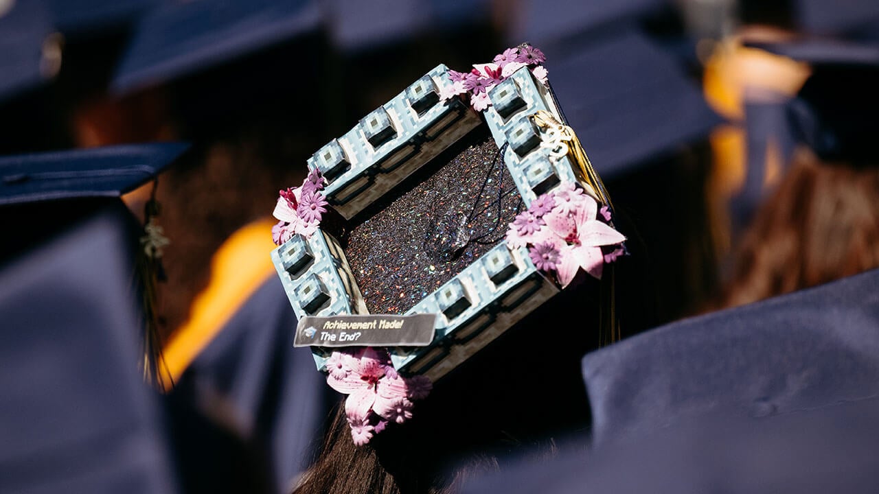 A grad cap that says, "Achievement made? The end!"