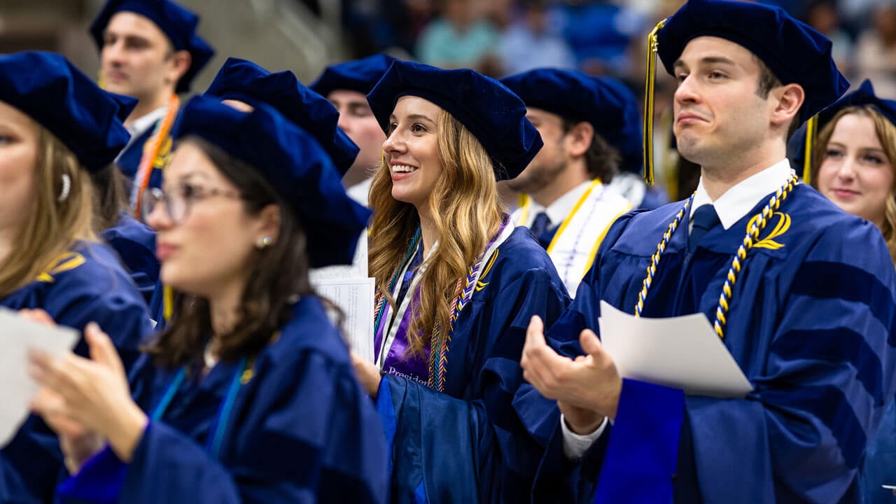 Graduates smile in the crowd during the Quinnipiac Law commencement ceremony.