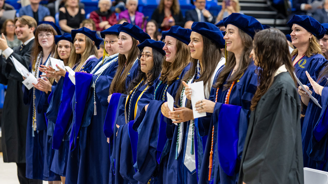 Graduates stand during speech