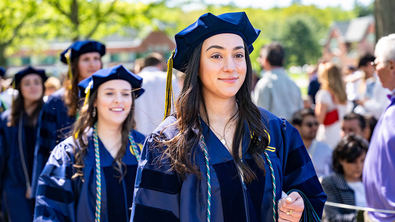 A graduate softly smiling