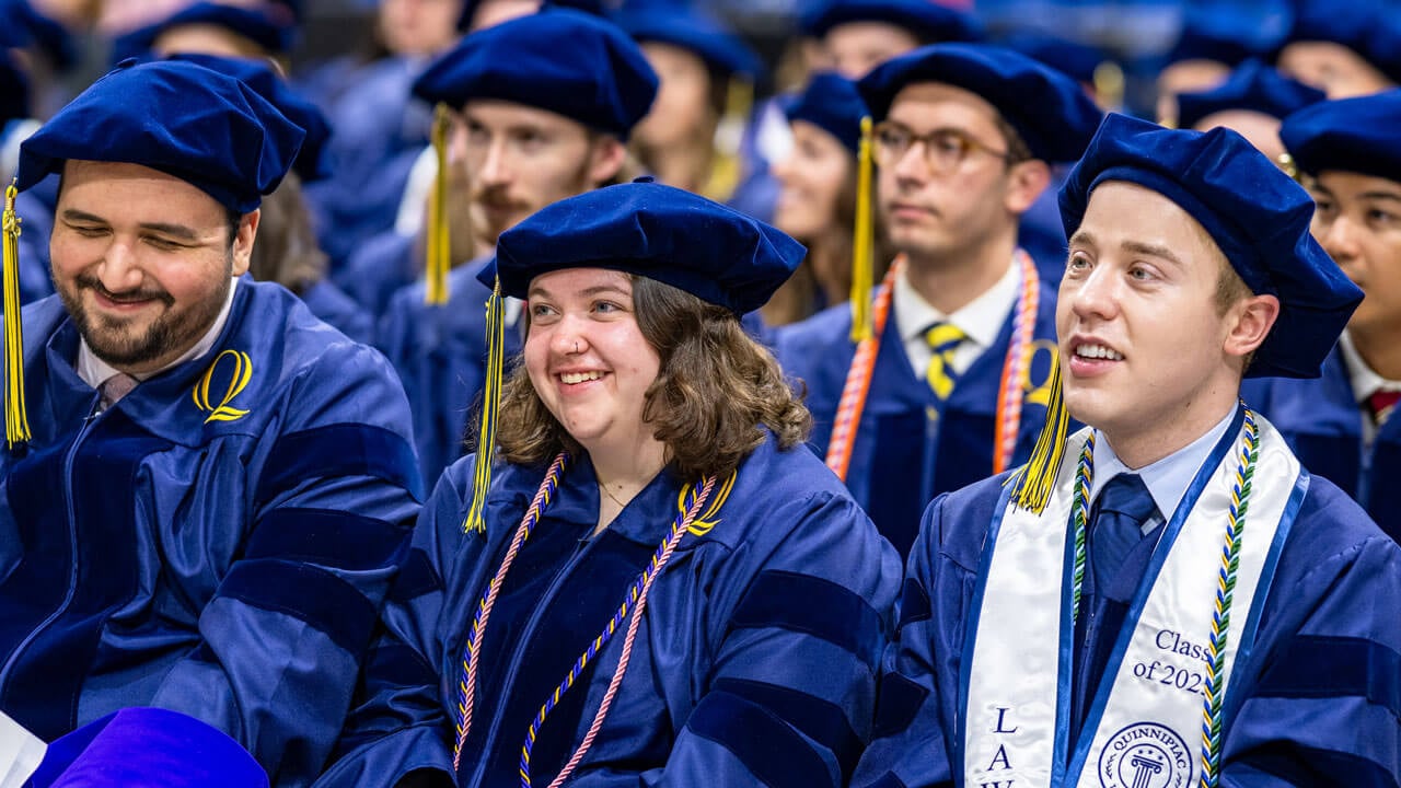 Graduates smile in the crowd during the Quinnipiac Law commencement ceremony.