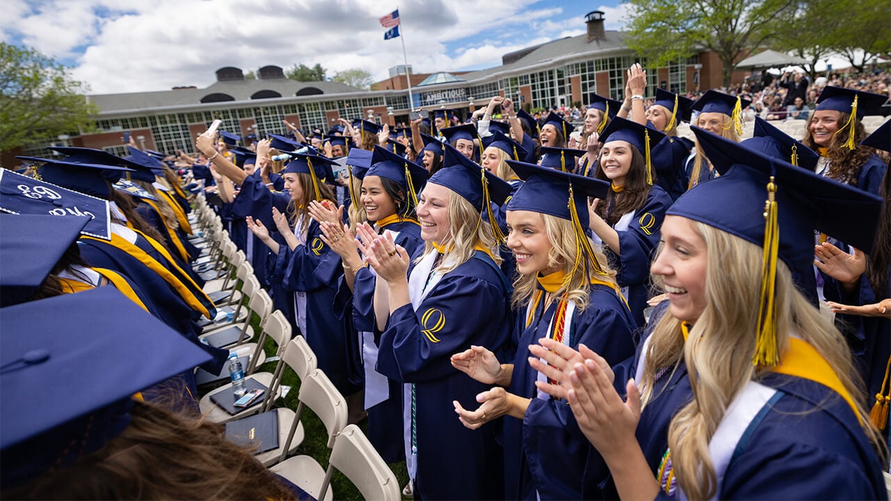 Students clapping at commencement.