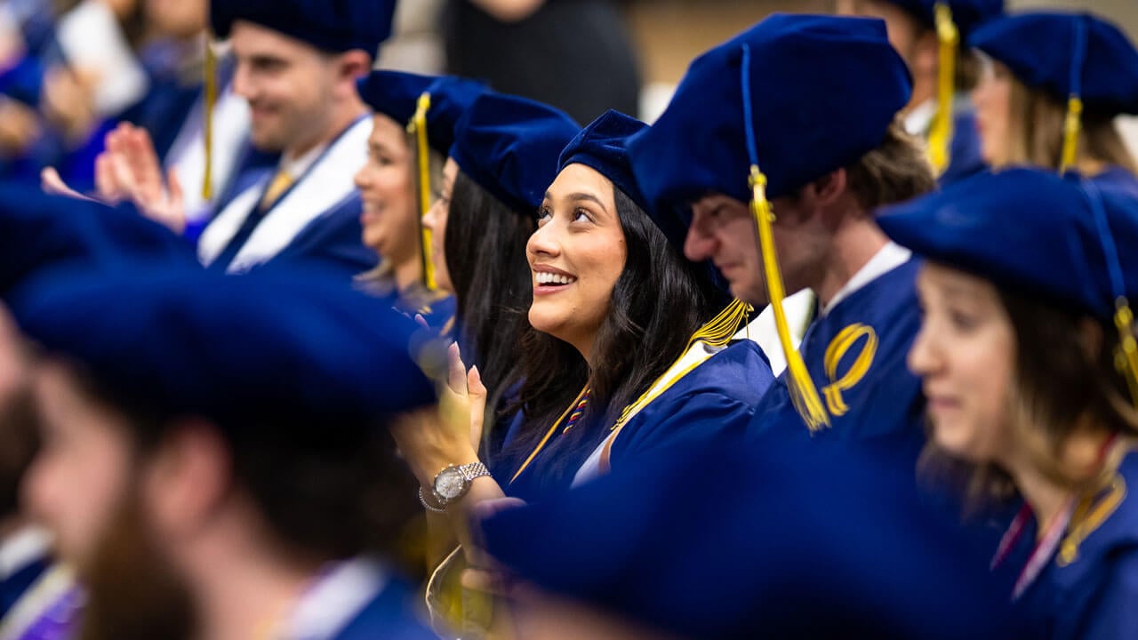 Graduates smile in the crowd during the Quinnipiac Law commencement ceremony.