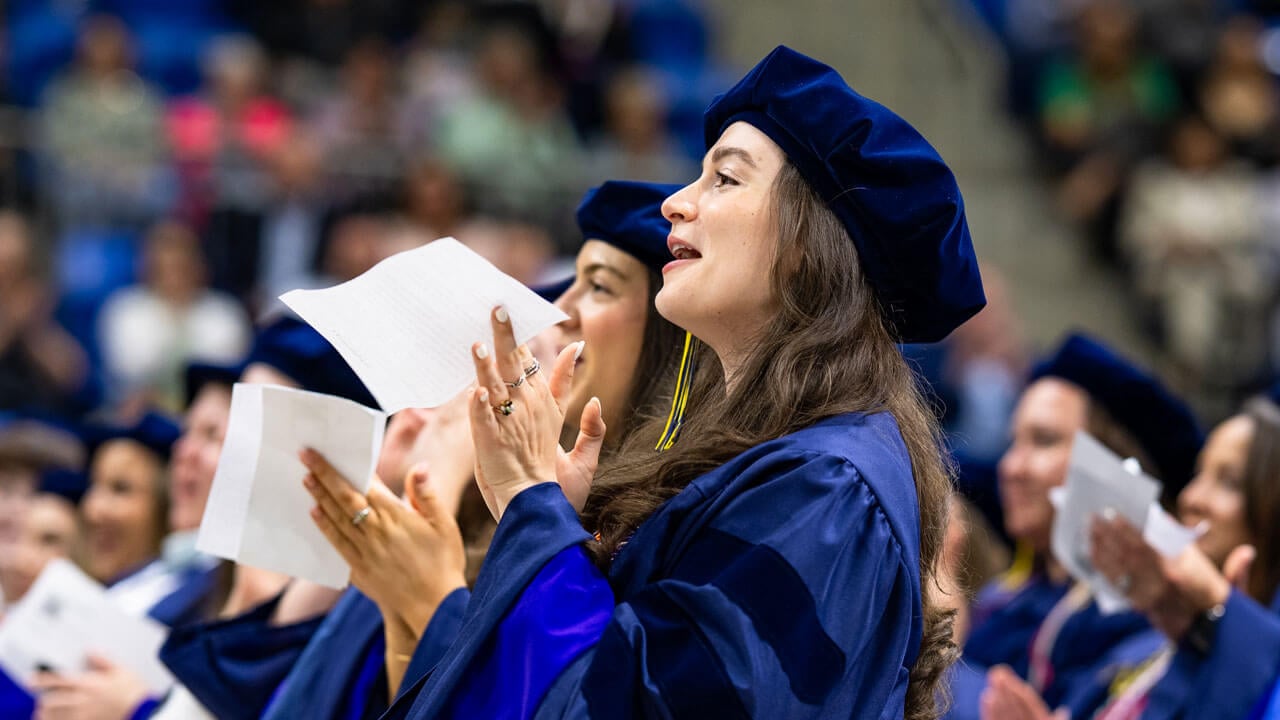 Graduate cheers and claps