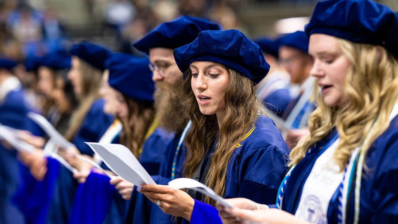 Graduates look down and read oath