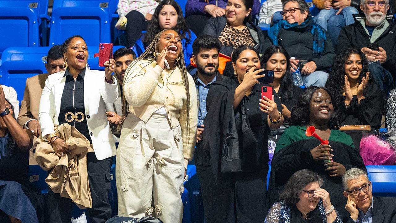 A group of family members cheering in the audience