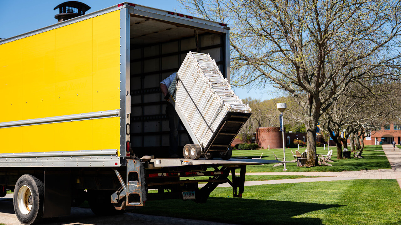 Chairs are removed from a truck.