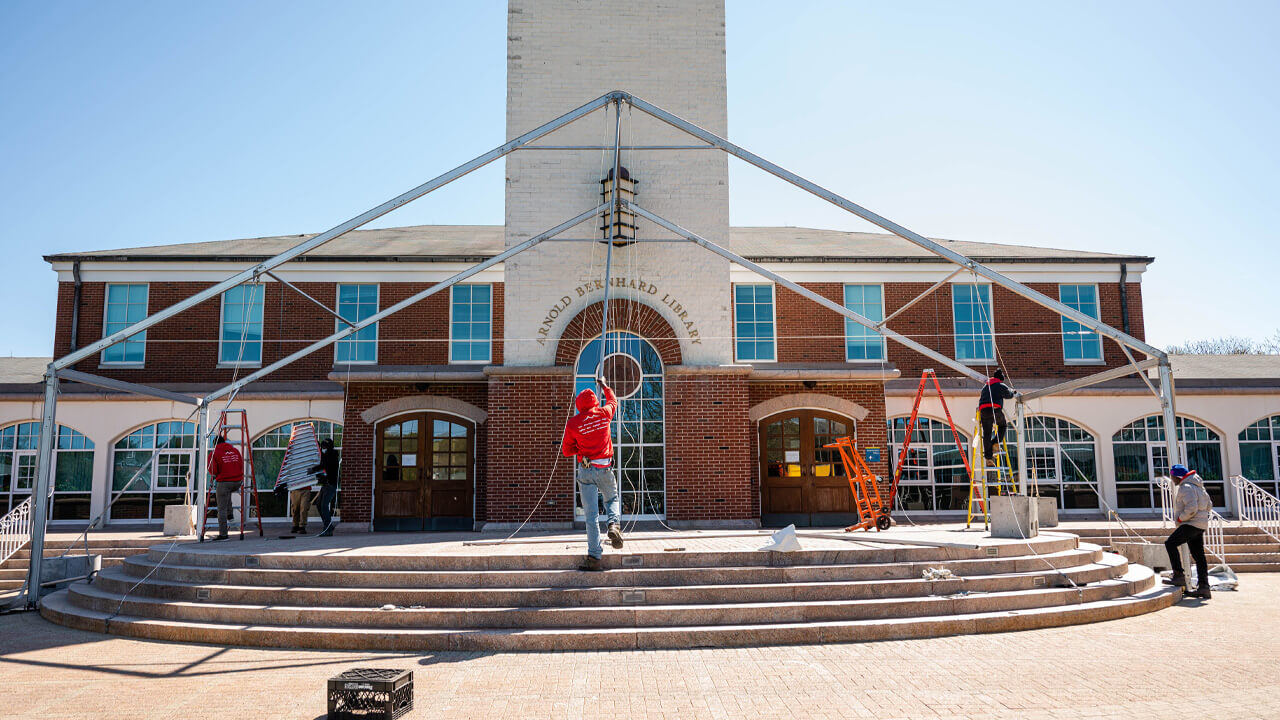A tent is erected on the steps of the library.