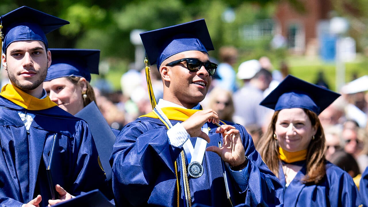 A student holding up a heart with their hands