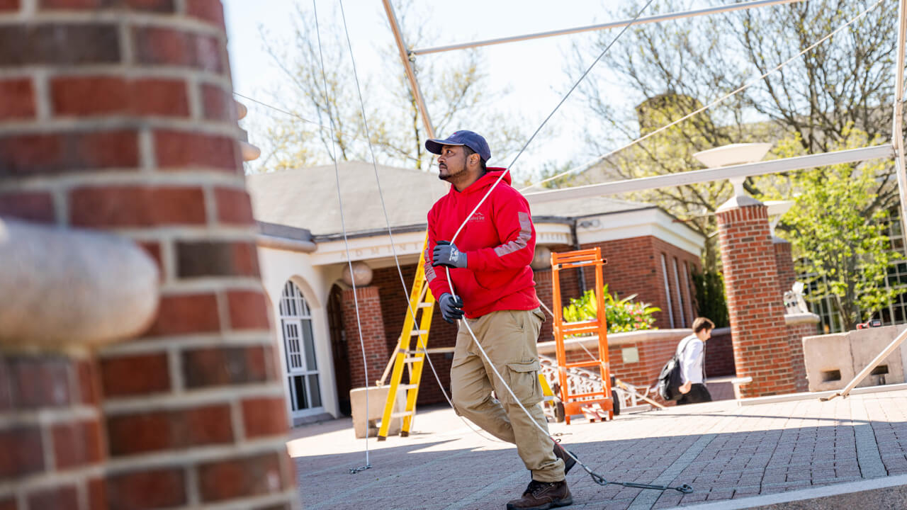People set up a tent on the Quad.