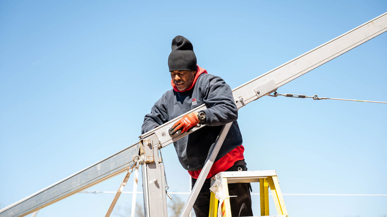 A man sets up a tent.