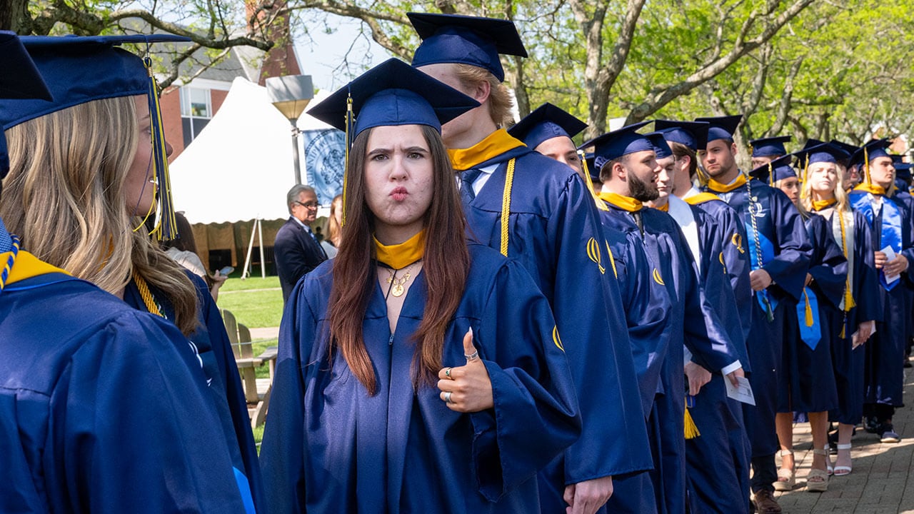 A graduate gives a thumbs up