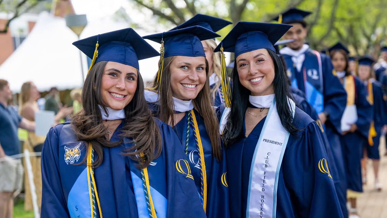 Three graduates pose for a picture together