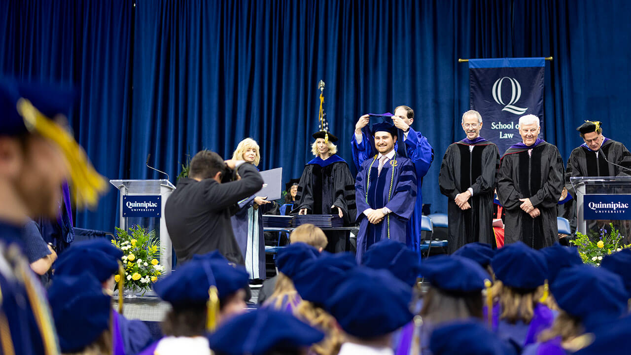 A Law graduate gets hooded on the stage