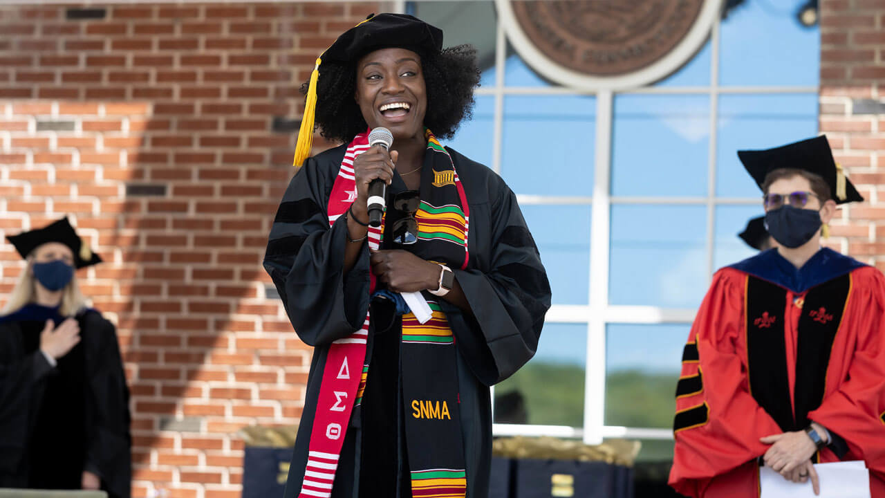 Medical school graduate singing national anthem