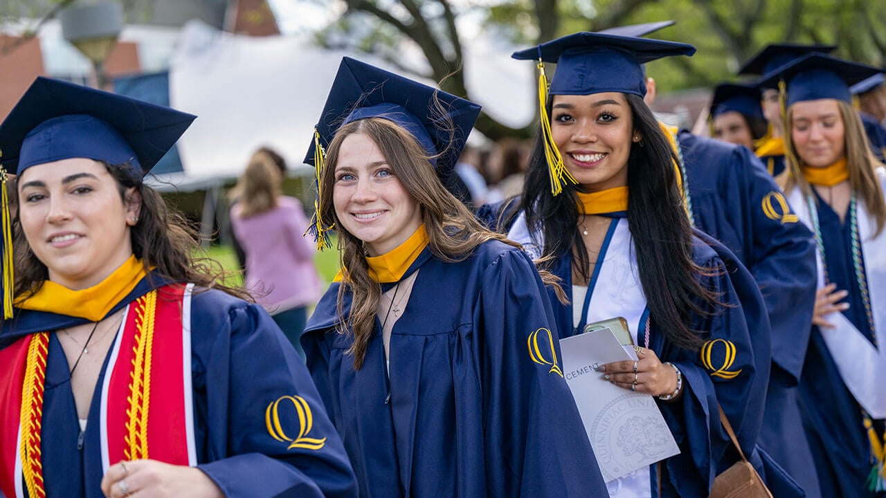 Graduates in the process line smile