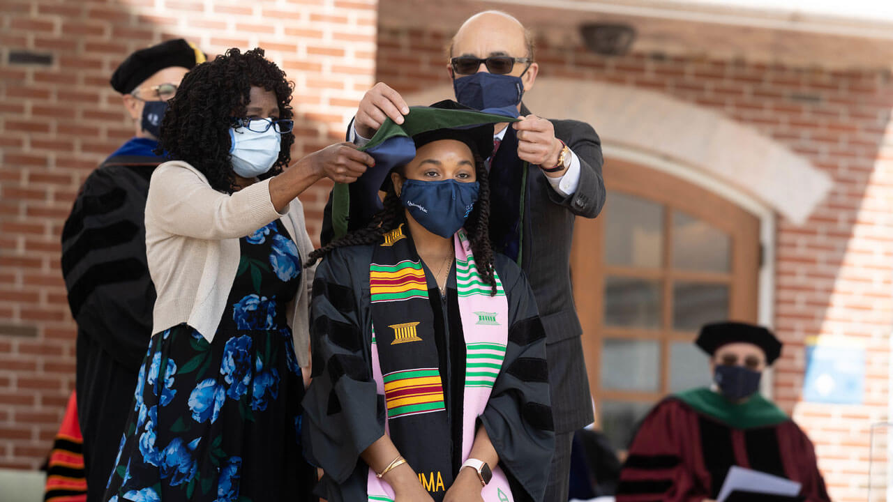 School of medicine graduate receiving her hood